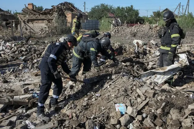 Rescuers dig through the remnants of the Voronov family house hit by the Russian missile in Radushne, Ukraine.